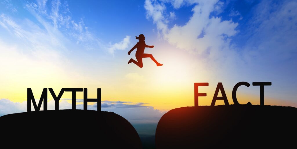 Woman jump through the gap between Myth to Fact on sunset.